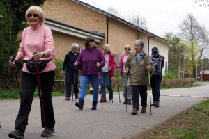 7 people walking, with hiking sticks