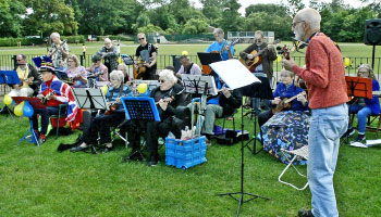 Musicians playing outside in a park 