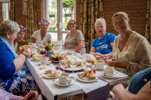 A table of people talking and eating food