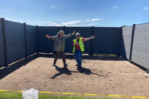 Two people standing in an empty plot