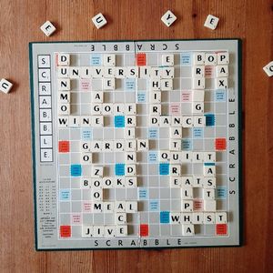 A scrabble board with words arranged in interlocking patterns - "University" "Dunmow" "Golf" "Fee" "Wine" "BOP", Bridge", "Dance", "Third", "Eye", "Garden", "Books", "Meal", "Ace", "Jive", "Quilt", "Tastes", "Whist", "Nature"