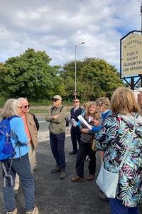 A group of people standing around outside 