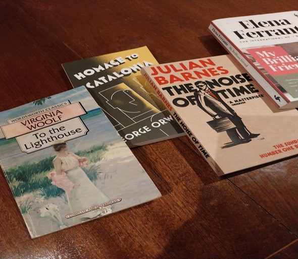 4 books on a wooden table