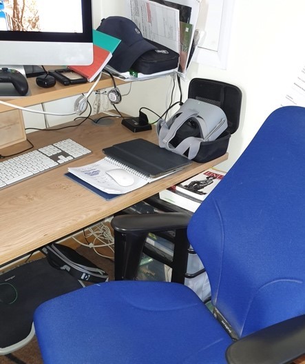 blue office chair and messy desk