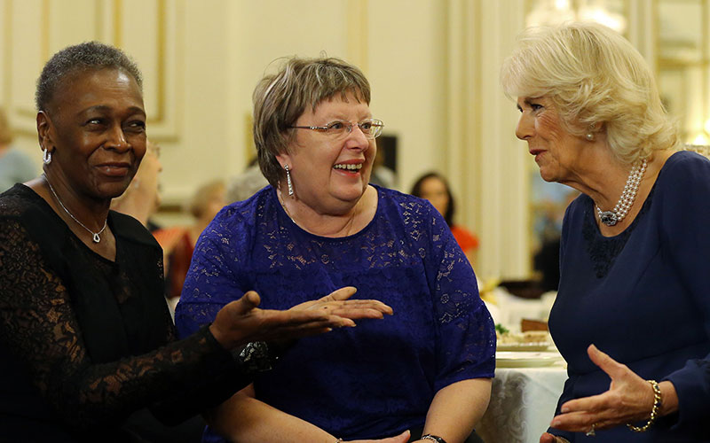 Camilla discusses the tea dance with a U3A member