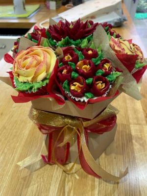 a bouquet of red and yellow roses made of icing