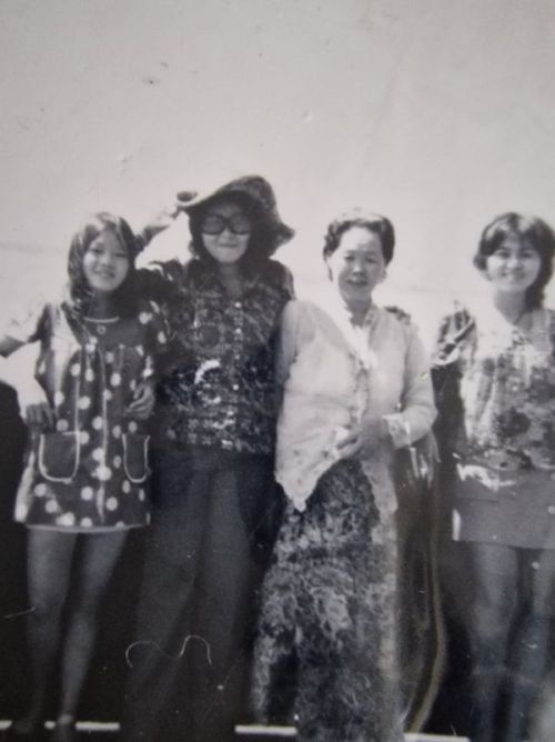 4 women in a row, black and white photo