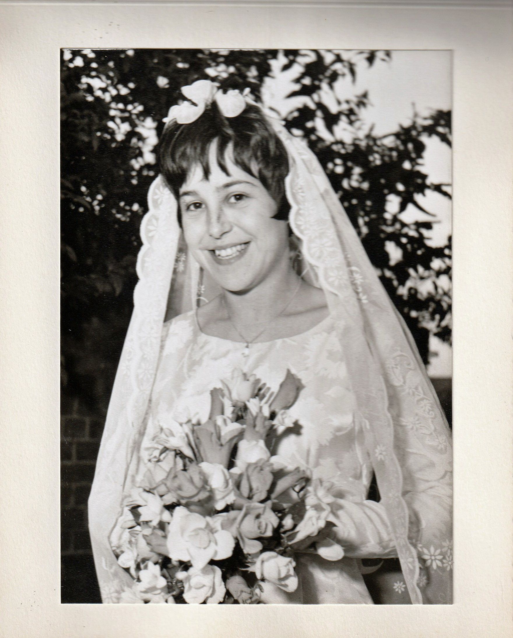 black and white photo of a woman smiling at her wedding