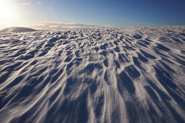 a sunrise above a flat snow scene