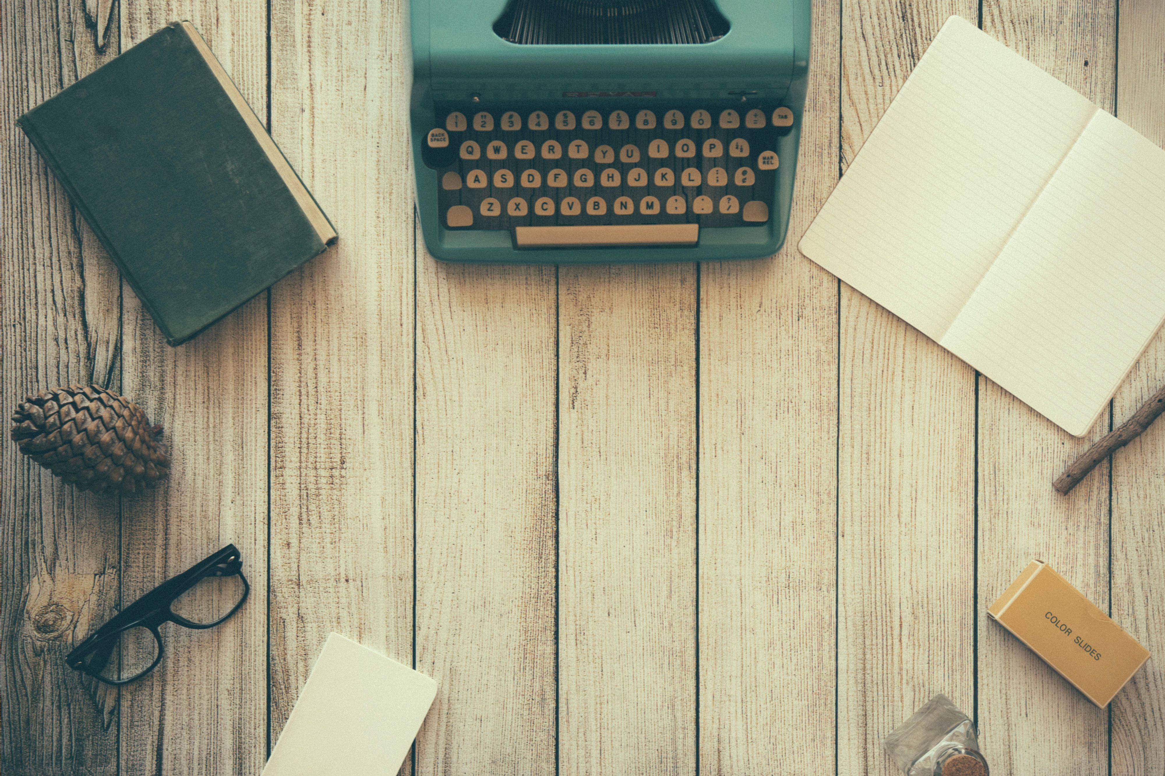 a typewriter on a wooden table
