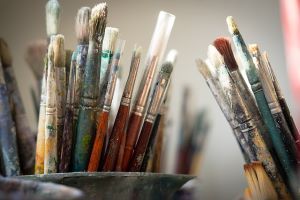 Two pots of used paintbrushes