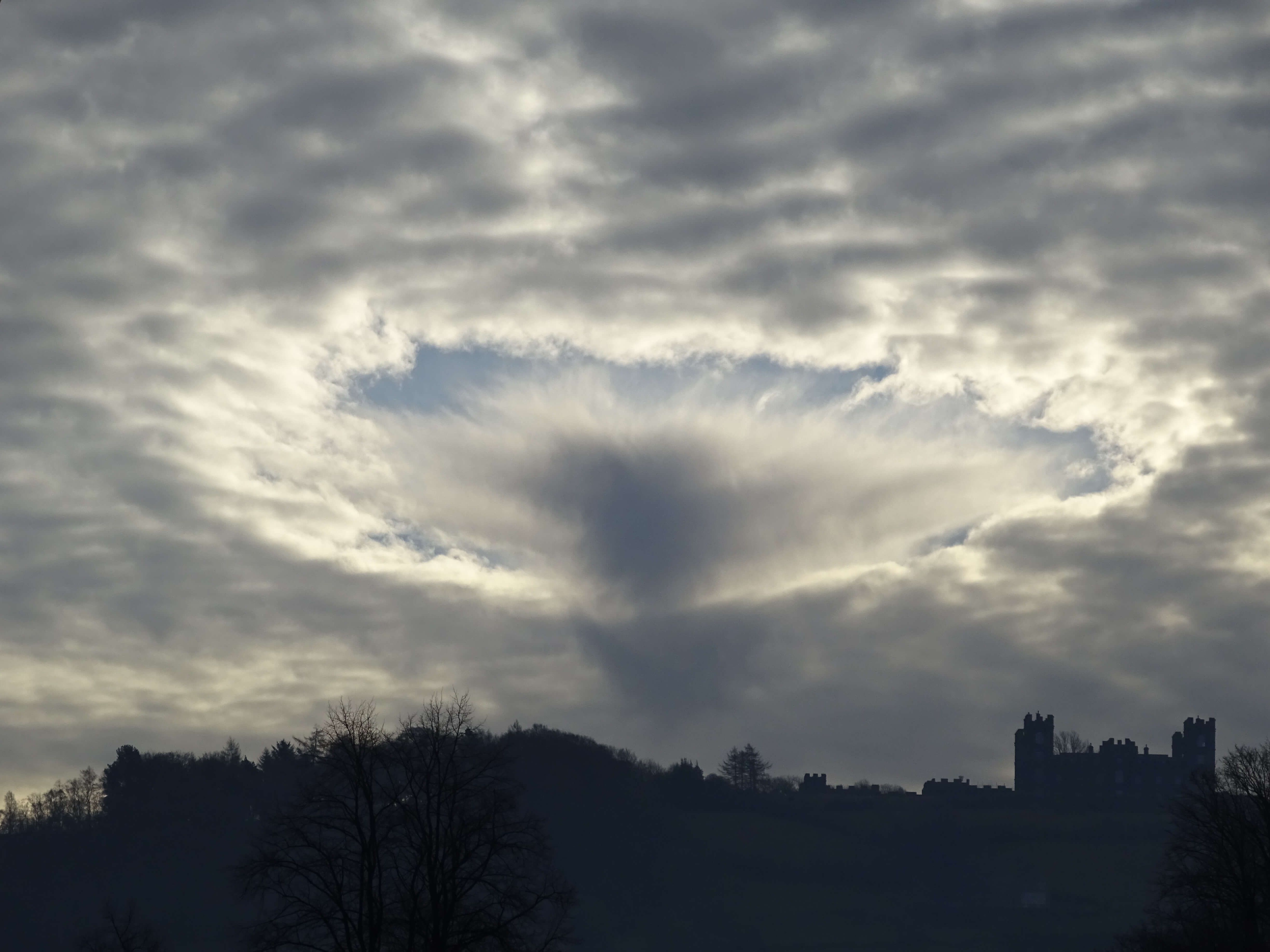 the clouds in the sky making a circular pattern