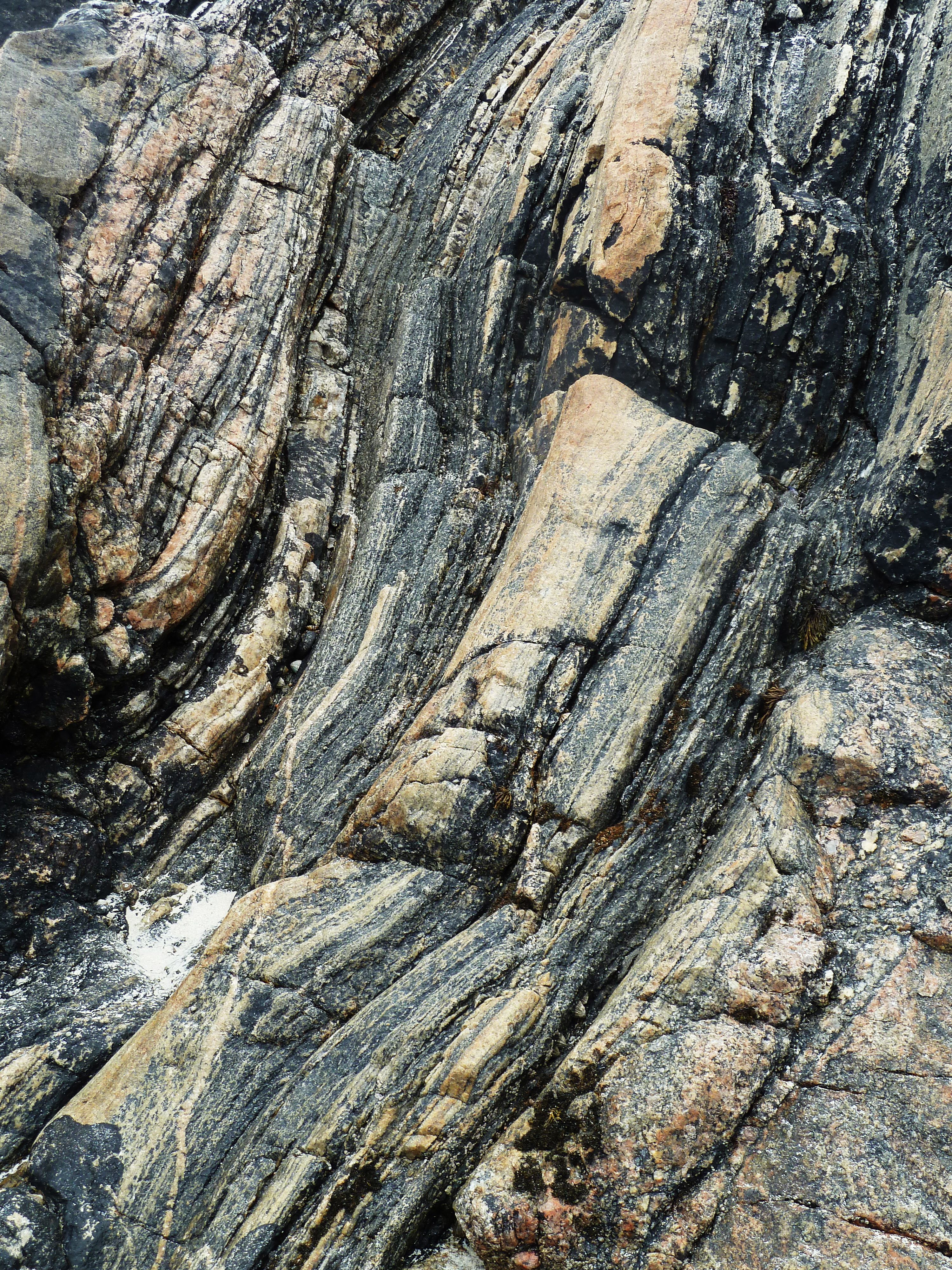 the intricate patterns in rock. They are vertical and hav many lines.