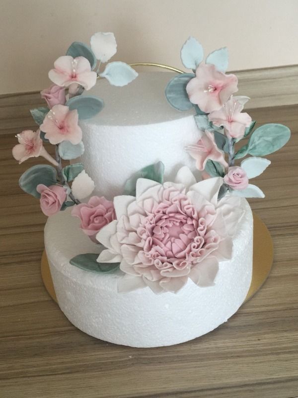 white cake with pastel pink sugarwork flowers