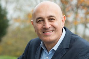 A photo of a man smiling outside