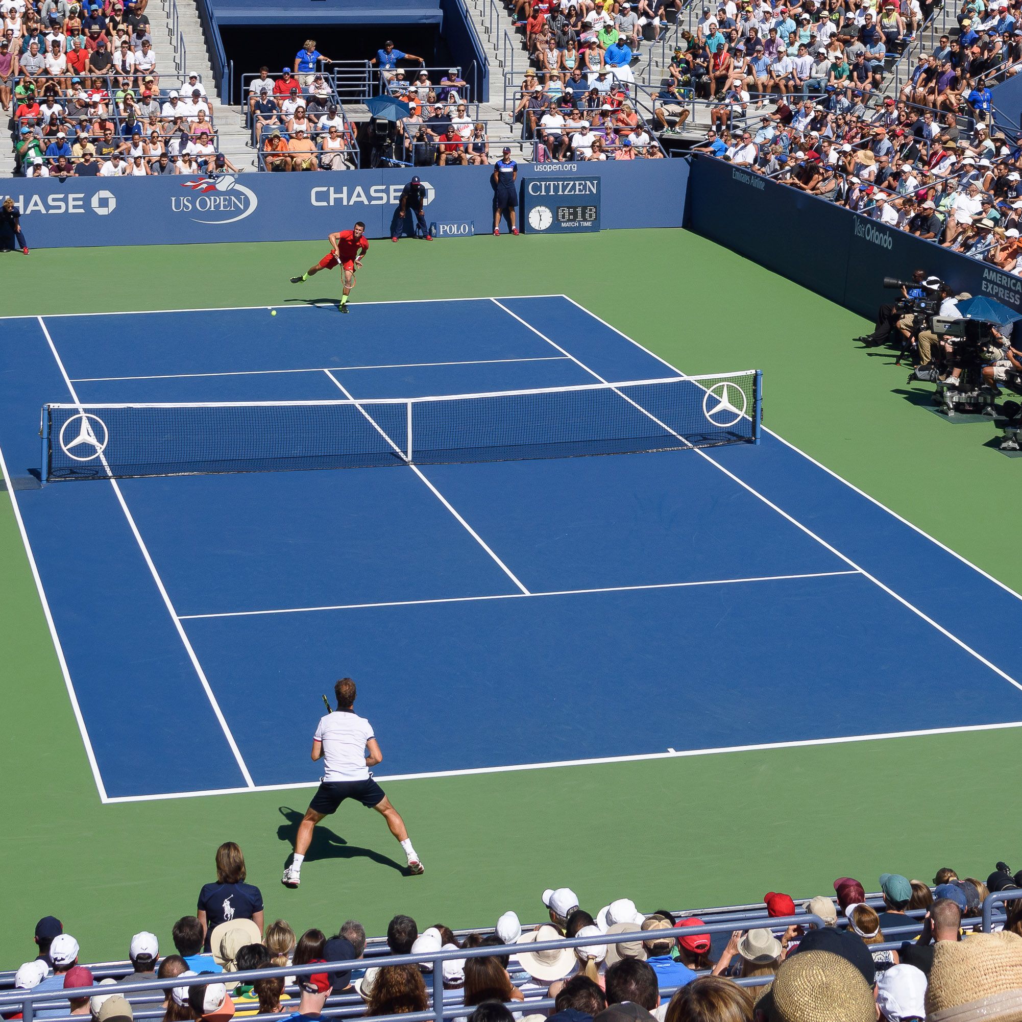 blue tennis court with two players