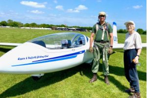 A woman standing next to a small plane